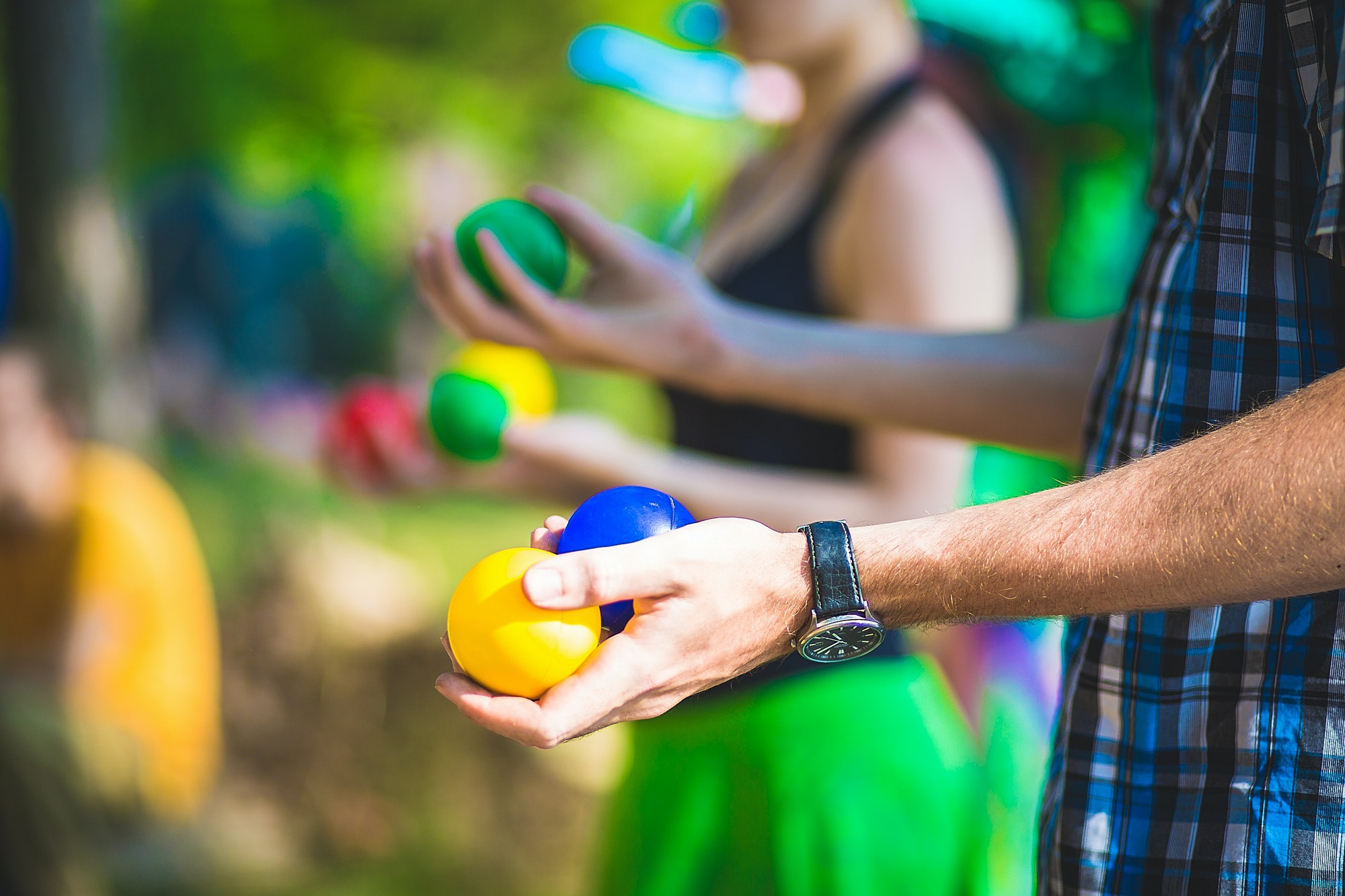 Young people are holding juggling balls. Juggling lessons. Close-up photo.